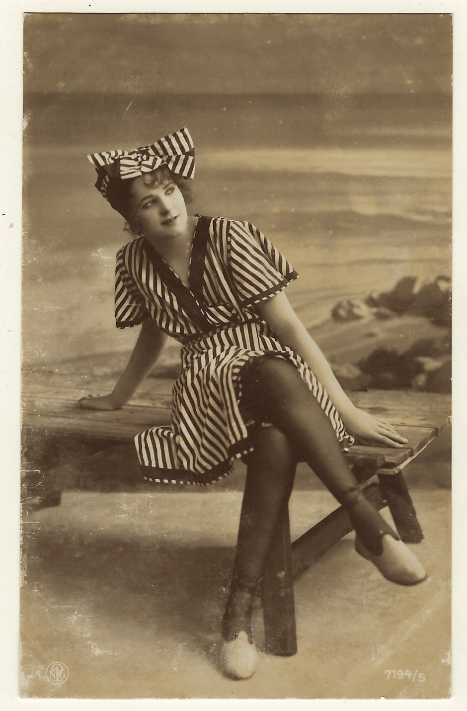 A DAY AT THE BEACH WITH A PRETTY WOMAN IN A FASHIONABLE STRIPED BATHING ...